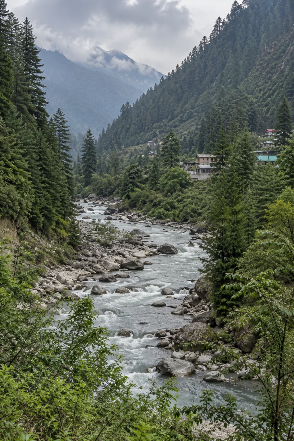 The Parvati River flowing between wooded slopes and modest valley homes