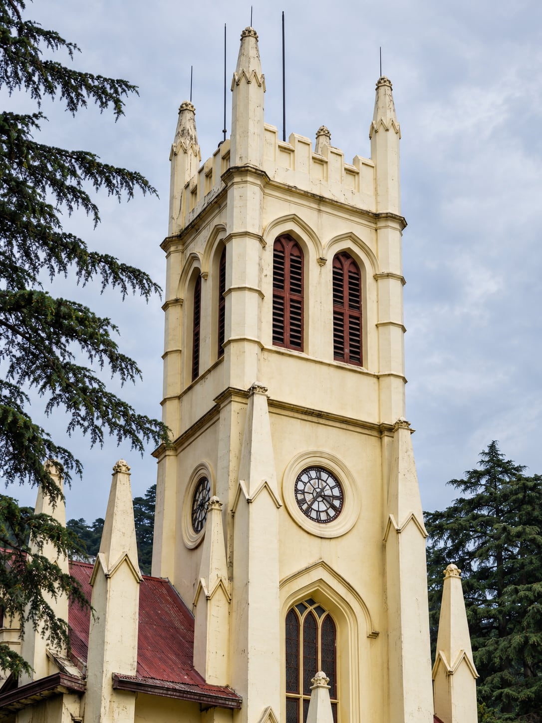 Illustration of Christ Church's pale-yellow clock tower and pointed windows in Shimla.